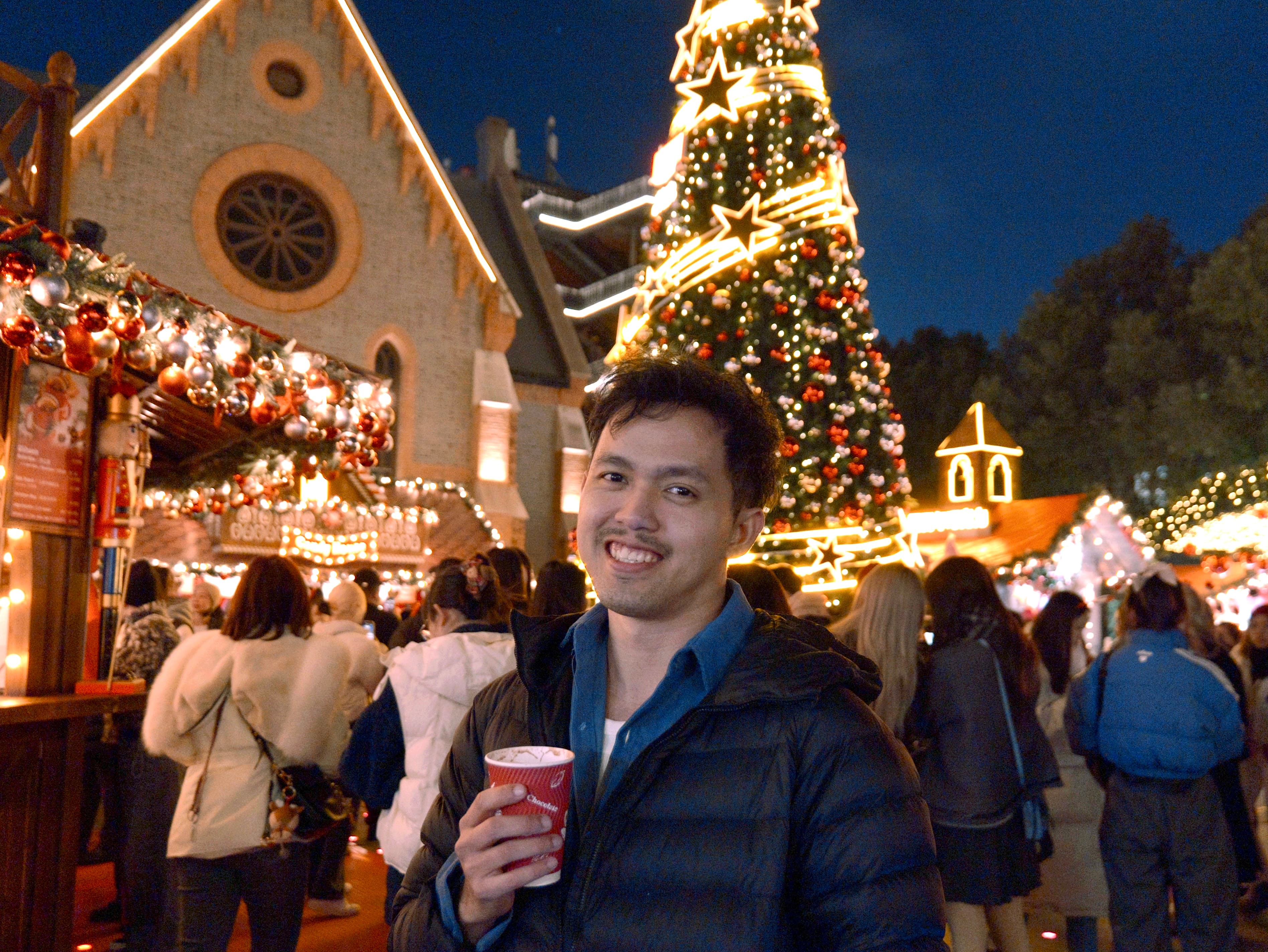 Pam holding a hot chocolate at a Christmas market